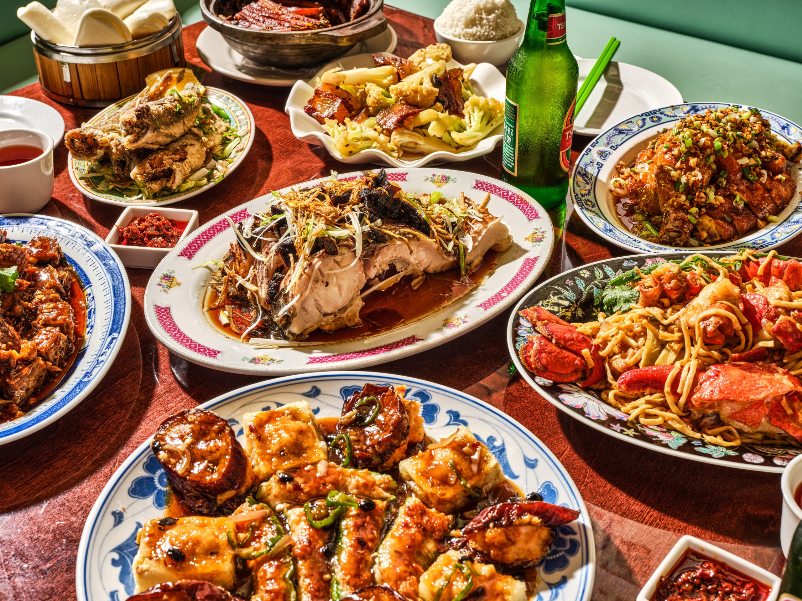Dishes being shared across a table at Uncle Lou