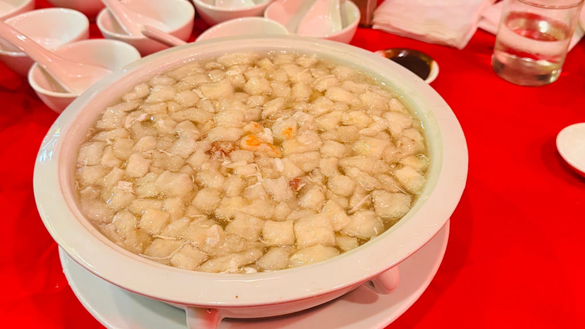 A large bowl of seafood soup with fish maw