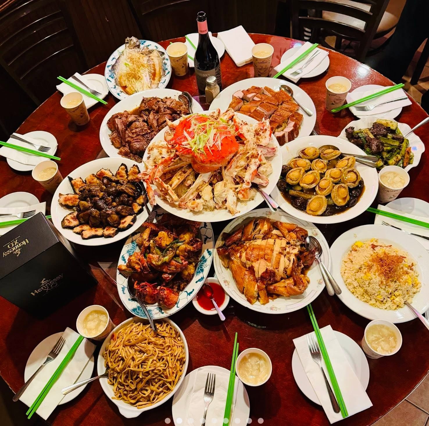 An overhead view of a large table filled with Chinese dishes