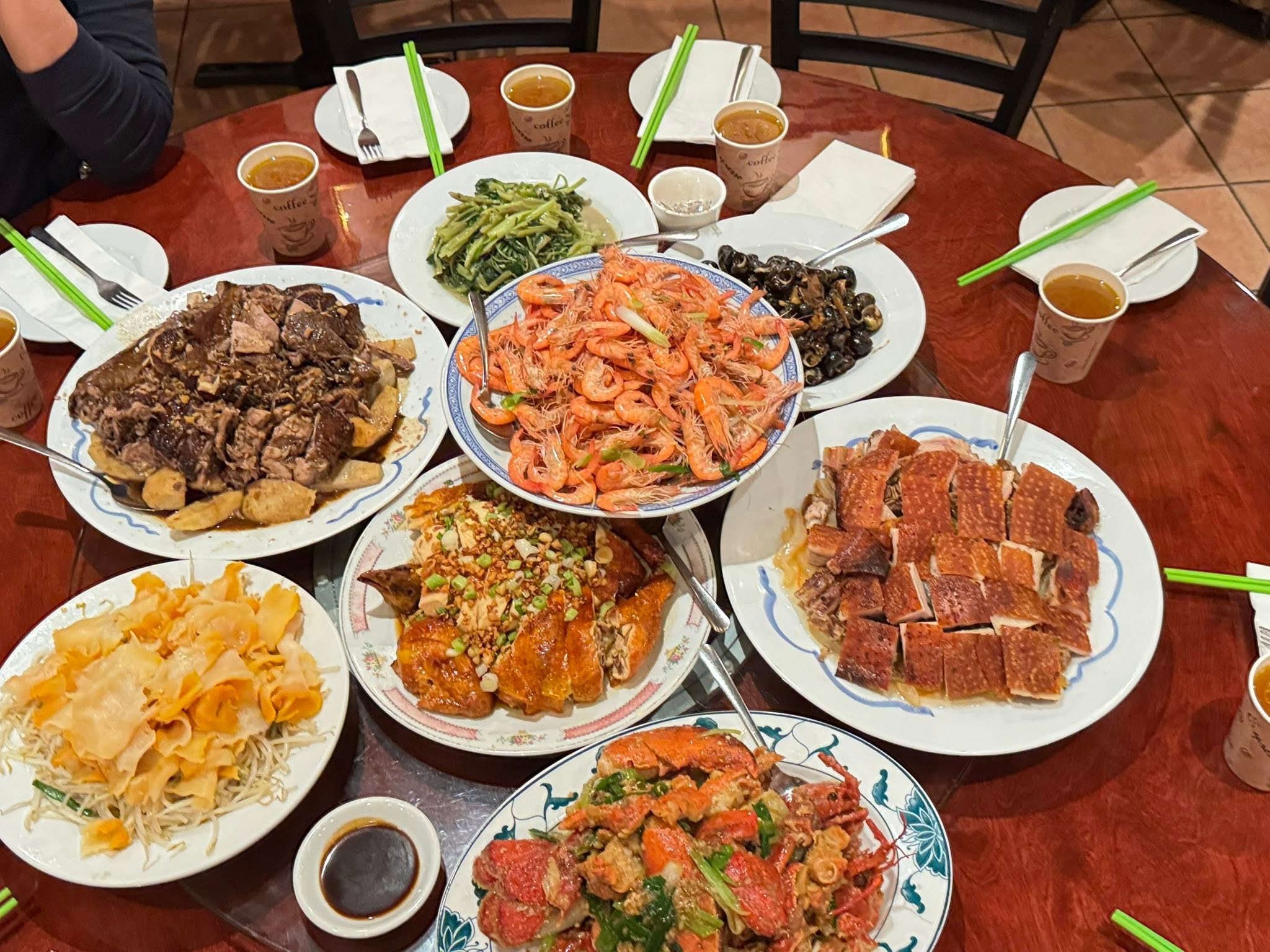 Several dishes spread across a round restaurant table