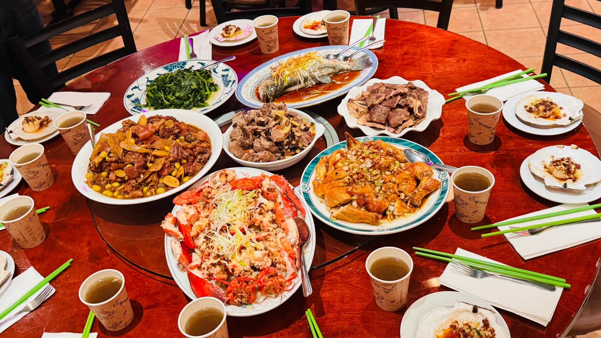 A round table filled with seafood, vegetables, and other dishes