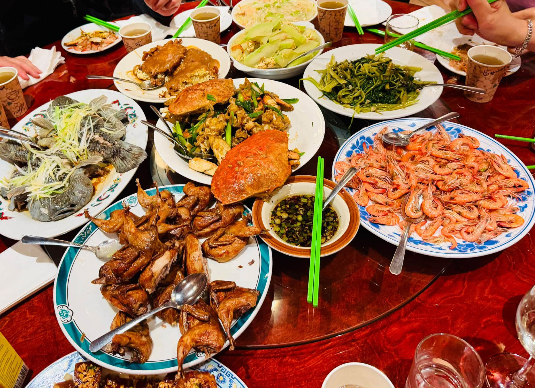 An overhead view of seafood and other dishes shared at Uncle Lou