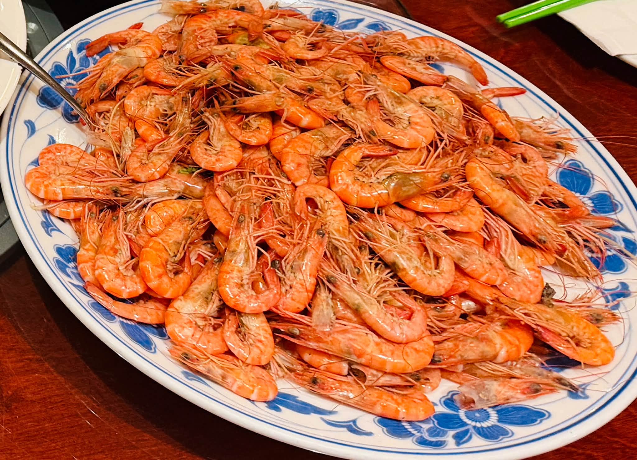 A large platter of cooked shrimp